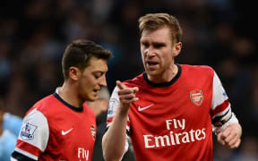 Arsenal players Mesut Ozil and Per Mertesacker.