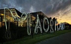 A luminous Māoriland sign outside Ngā Purapura in Ōtaki