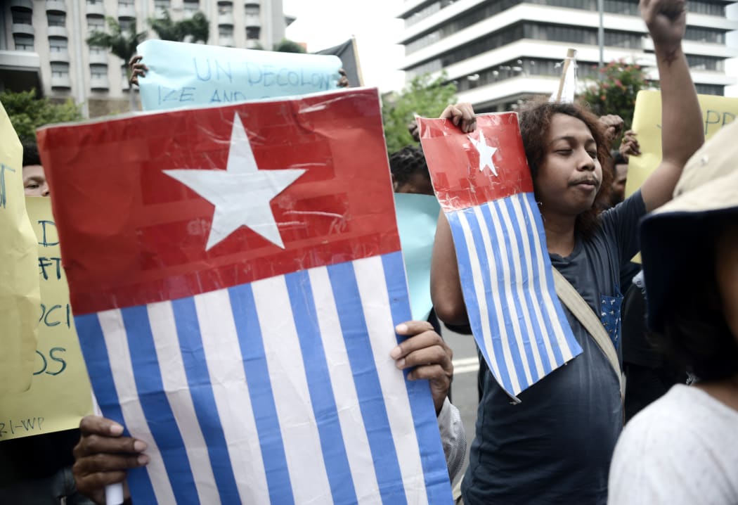 Protesters display the West Papuan pro-independence "Morning Star" flag during a demonstration by mostly university students from Free Papua Organization and the Papua Student Alliance in Jakarta on April 3, 2017. -
