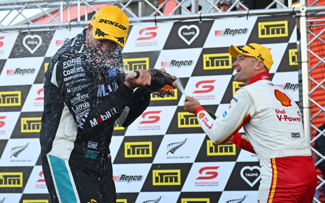 Winner Chaz Mostert (L) celebrates with second placed Will Davison following race two of the Taupo Supercars round.
