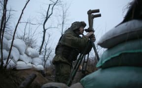 A Ukrainian serviceman is seen in the shelter at the front line position not far from Donetsk town, which is not under the control of the Ukrainian government, on 28 November 2021.