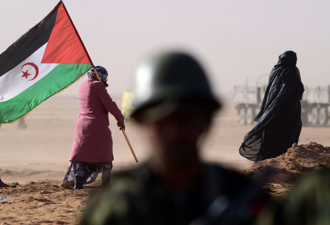 A Sahrawi woman holds a Polisario Front's flag during a 2016 ceremony to mark 40 years after the Front proclaimed the Sahrawi Arab Democratic Republic in the disputed territory of Western Sahara.