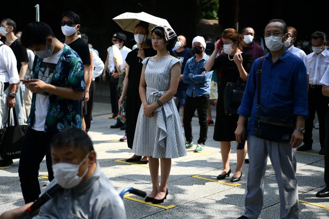 People pray at the Yasukuni shrine in Tokyo on August 15.