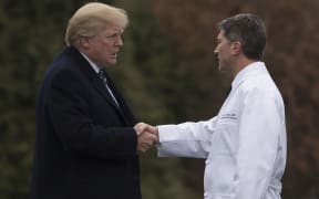 US President Donald Trump shakes hands with White House Physician Rear Admiral Dr. Ronny Jackson, following his annual physical.