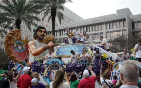 People participate in a Mardi Gras-style parade in New Orleans, Louisiana ahead of Super Bowl LIX, where the Kansas City Chiefs will play the Philadelphia Eagles, in New Orleans, Louisiana, on 8 February 2025. (Photo by TIMOTHY A. CLARY / AFP)