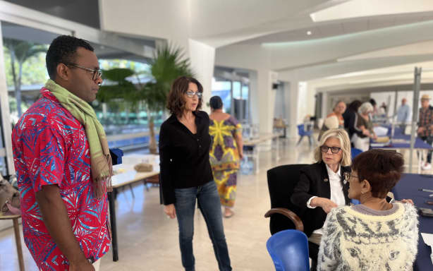 Noumea mayor Sonia Lagarde (sitting down facing camera) behind a registration desk at Noumea’s town hall.
