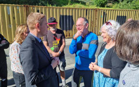 Yellow stickered residents Greg Bate and Ellie Fijn talk to Prime Minister Chris Hipkins about their concerns.