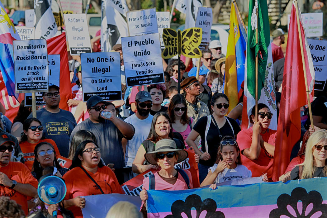 Protesters march along the United States-Mexico border during a rally to show solidarity with the migrant caravan on November 25, 2018.