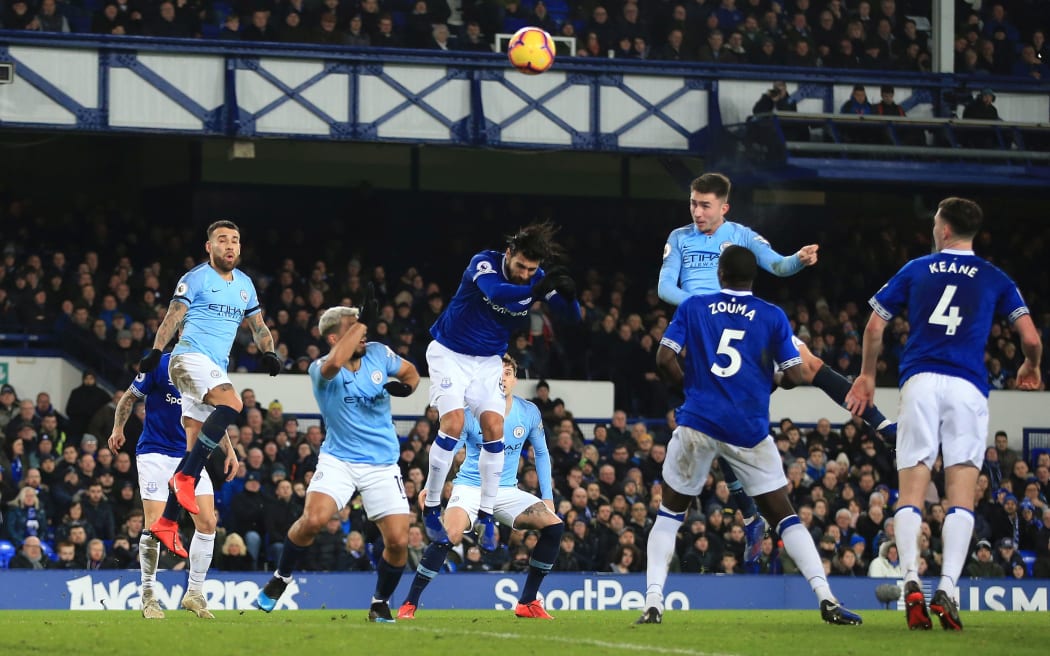 Aymeric Laporte of Manchester City scores against Everton.