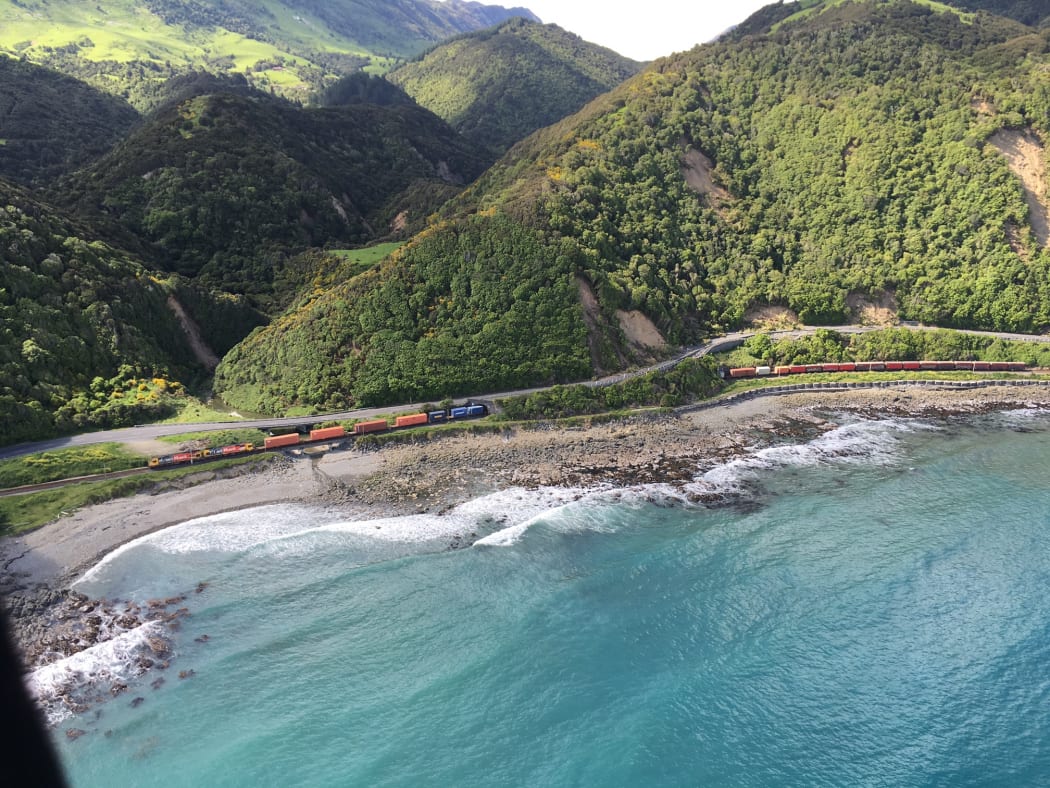 A train is trapped between slips on SH1 after Monday's earthquake.