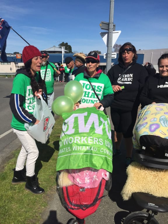 People wave balloons and banners at a protest at the Wairoa Bridge in Hawke's Bay over AFFCO employment contracts.