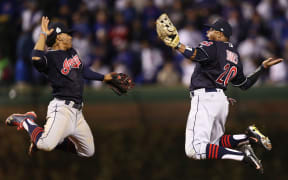 Francisco Lindor and Rajai Davis celebrate Cleveland's victory in game four of the Fall Classic.
