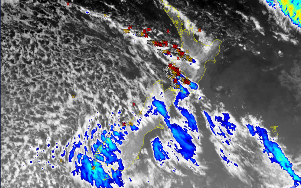 A composite satellite image of stormy weather and lightning strikes sweeping much of Aotearoa, on Saturday morning.