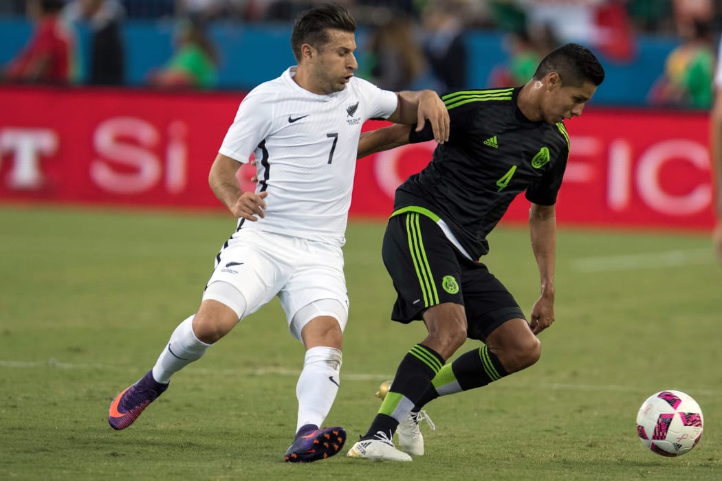 Kosta Barbarouses challenges for the ball against Mexico