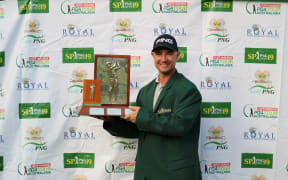 Peter Cooke lifts the PNG Open trophy.