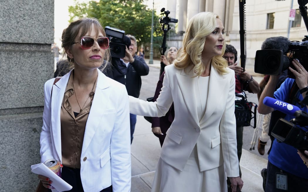 Annie Farmer, left, and her lawyer Sigrid McCawley arrive at US District Court for the Southern District of New York on 28 June 2022, for the sentencing hearing of Ghislaine Maxwell.