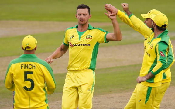 Australia's Josh Hazlewood (2L) celebrates taking the wicket of England's Joe Root for one run during the one-day international (ODI) cricket match between England and Australia at Old Trafford in Manchester on September 11, 2020. (Photo by Jon Super / POOL / AFP)