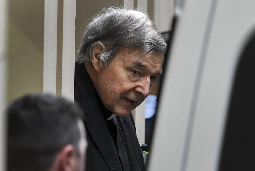 Cardinal George Pell is escorted in handcuffs from the Supreme Court of Victoria in Melbourne on August 21, 2019.