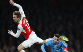 Nacho Monreal of Arsenal sails above Lionel Messi of FC Barcelona, Champions League 2016.
