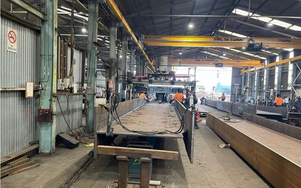 The first of 15 bridge beams being fabricated by teams working around the clock in Napier.