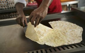 Man preparing roti tisu