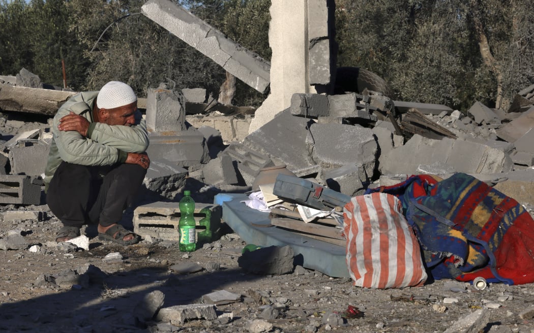 A man sits amid the rubble following Israeli bombardment in Rafah in the southern Gaza Strip on January 13, 2024, amid ongoing battles between Israel and Palestinian militant group Hamas. (Photo by AFP)