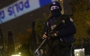 A police officer stands guard along a street after a female suicide bomber was killed in Istanbul.