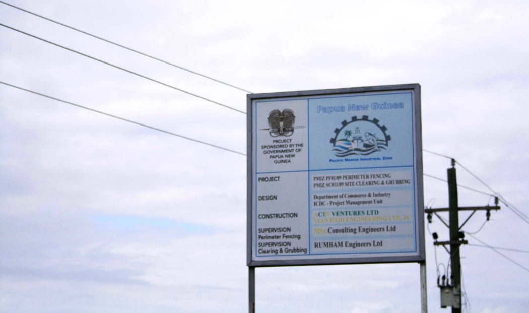 A sign on the perimeter fencing for the  Pacific Marine Industrial Zone (PMIZ) project in Madang, one of the few structures built from almost ten million US dollars spent on the project by Papua New Guinea's government in the past decade.