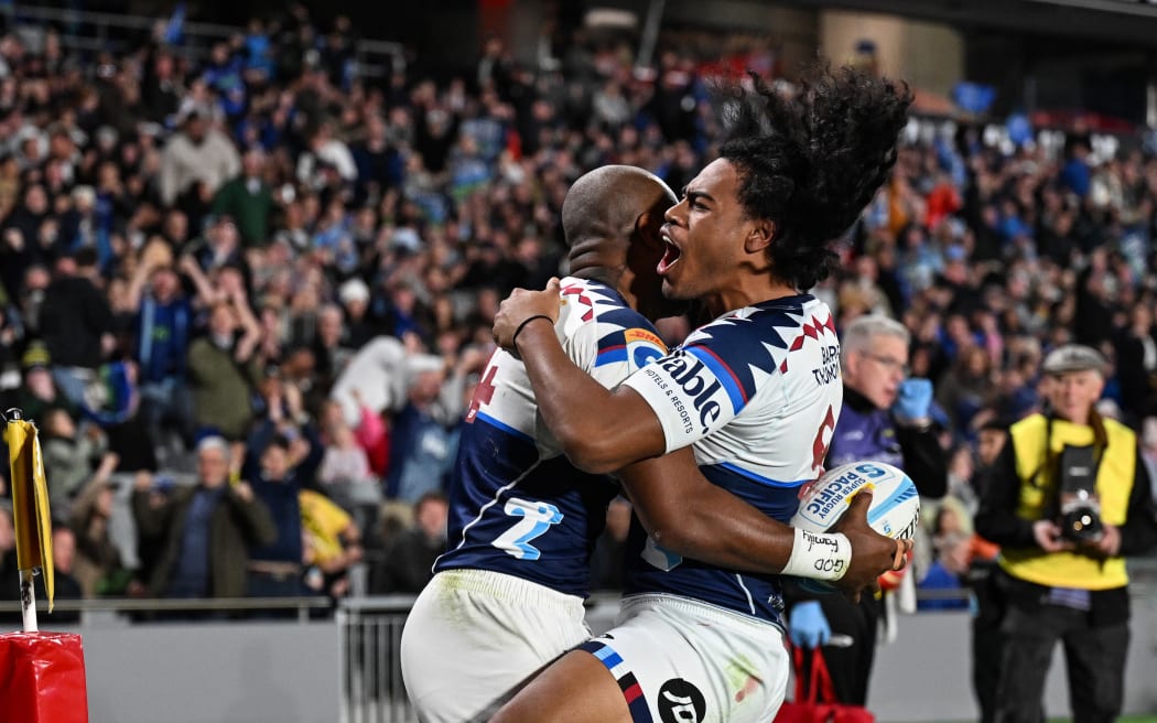 Mark Tele'a of the Blues celebrates his try with Taufa Funaki.