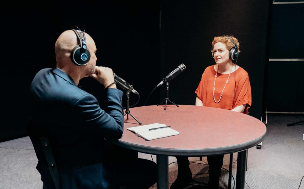Reverend Frank Ritchie sitting opposite a round table across from RNZ journalist Susie Ferguson.