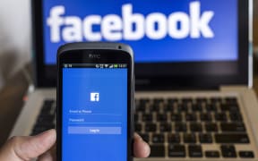 CHIANG MAI, THAILAND - OCTOBER 21, 2014: Facebook application sign in page on smartphone and facebook logo on background.