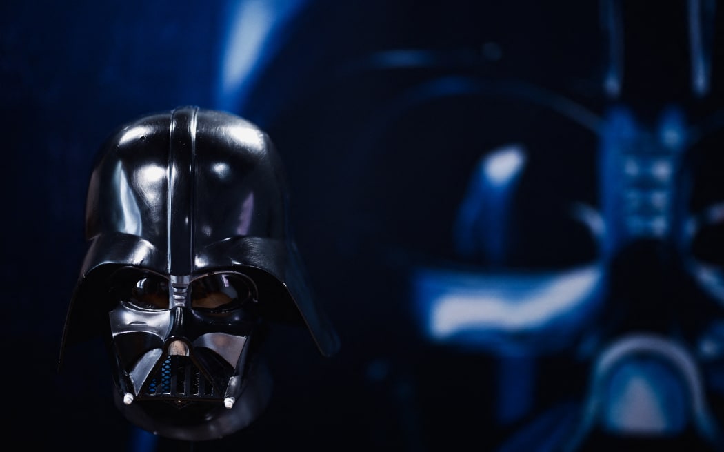 (FILES) A photo shows an original Darth Vader helmet used during the filming of Star Wars Episode 5 "The Empire Strikes Back", the latest acquisition of the Miniature and Cinema Museum in Lyon, eastern France, on June 13, 2024. James Earl Jones, the actor whose rich baritone provided the voice for "Star Wars" villain Darth Vader, has died, his representatives said September 9, 2024. He was 93. Jones, who also voiced King Mustapha in Disney’s animated feature "The Lion King" had a prolific and varied career over six decades. (Photo by OLIVIER CHASSIGNOLE / AFP)