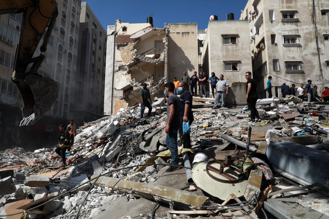 Palestinians inspect a destroyed house, after it was struck by Israeli strikes, in Gaza City this week.