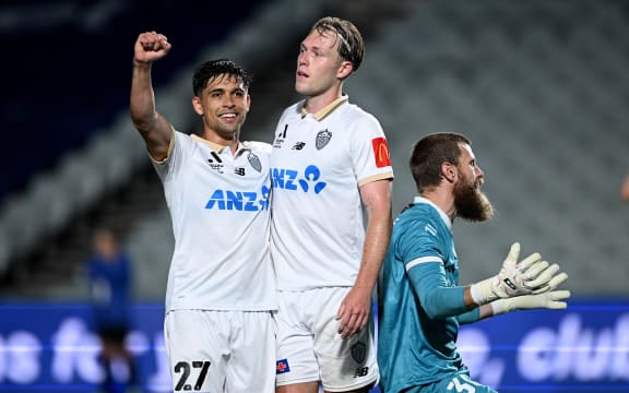 Sam Cosgrove of Auckland (centre) celebrates with Logan Rogerson (left) after scoring a goal during the A-League.