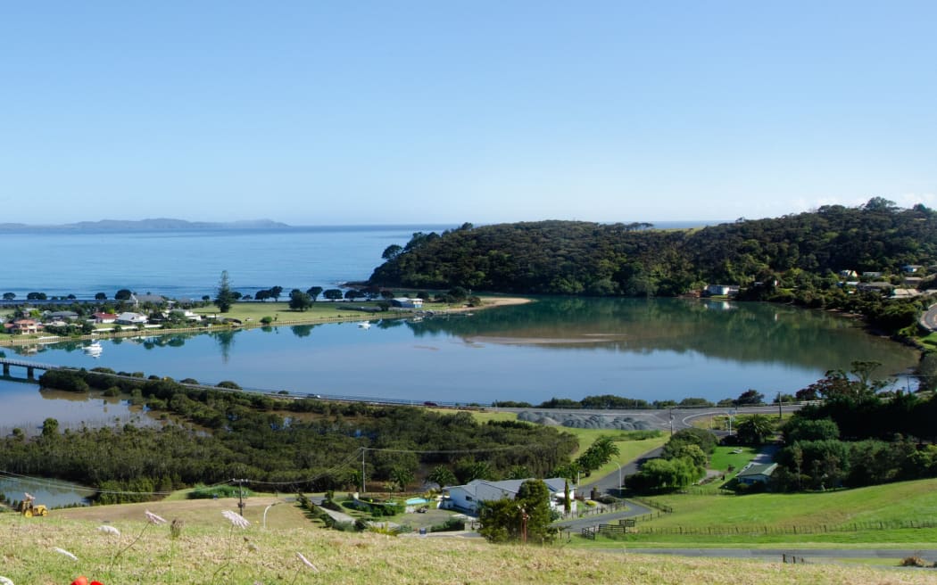 Aerial view of Taipa town, river, inlet and Doubtless Bay at the background in Northland, New Zealand.