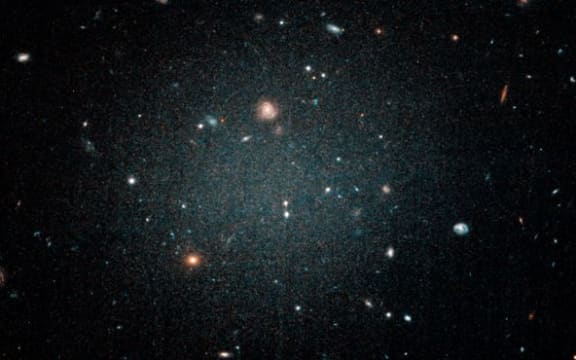 The NGC1052-DF2 galaxy is so thin other galaxies can be seen through it, as seen in this image from the Hubble telescope.