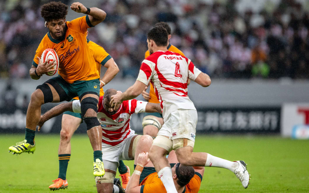 Australia's Rob Valetini runs past Japan's Jack Cornelsen during the international rugby union Test match between Japan and Australia at the National Stadium in Tokyo on October 25, 2025. (Photo by Philip FONG / AFP)