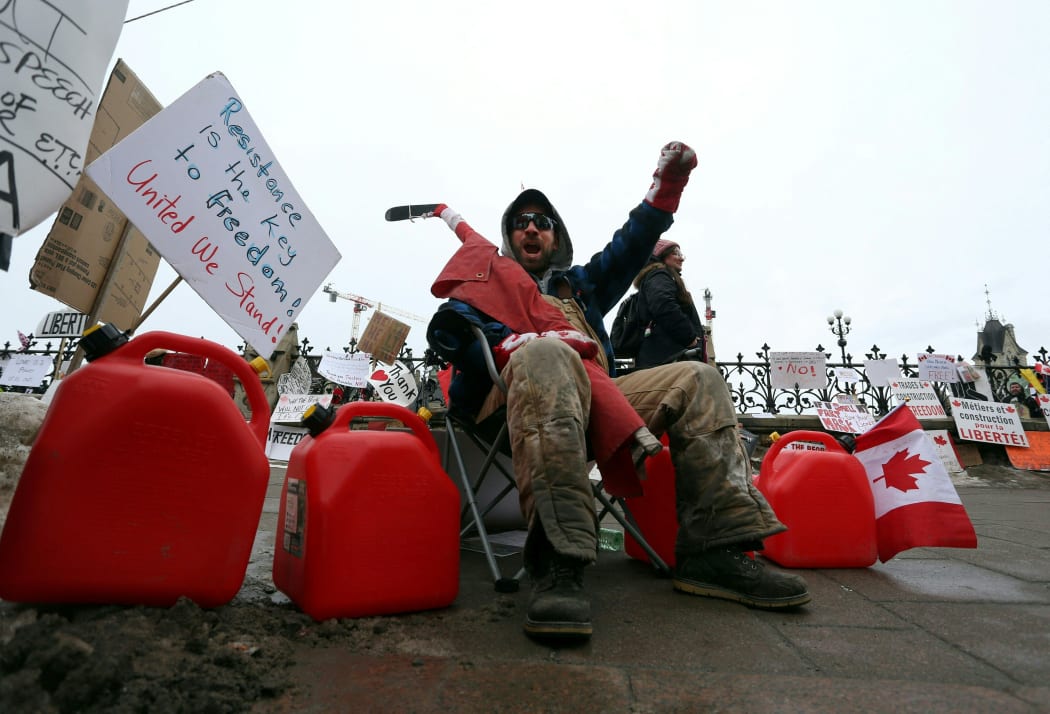 A man protests in front of the Parliament as demonstrators continue to protest the vaccine mandates on February 11, 2022 in Ottawa, Canada.