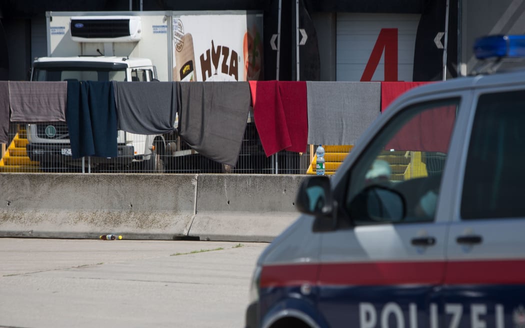 The refrigerated truck, in which bodies of 71 migrants were found, parked at the border in Nickelsdorf, Austria.