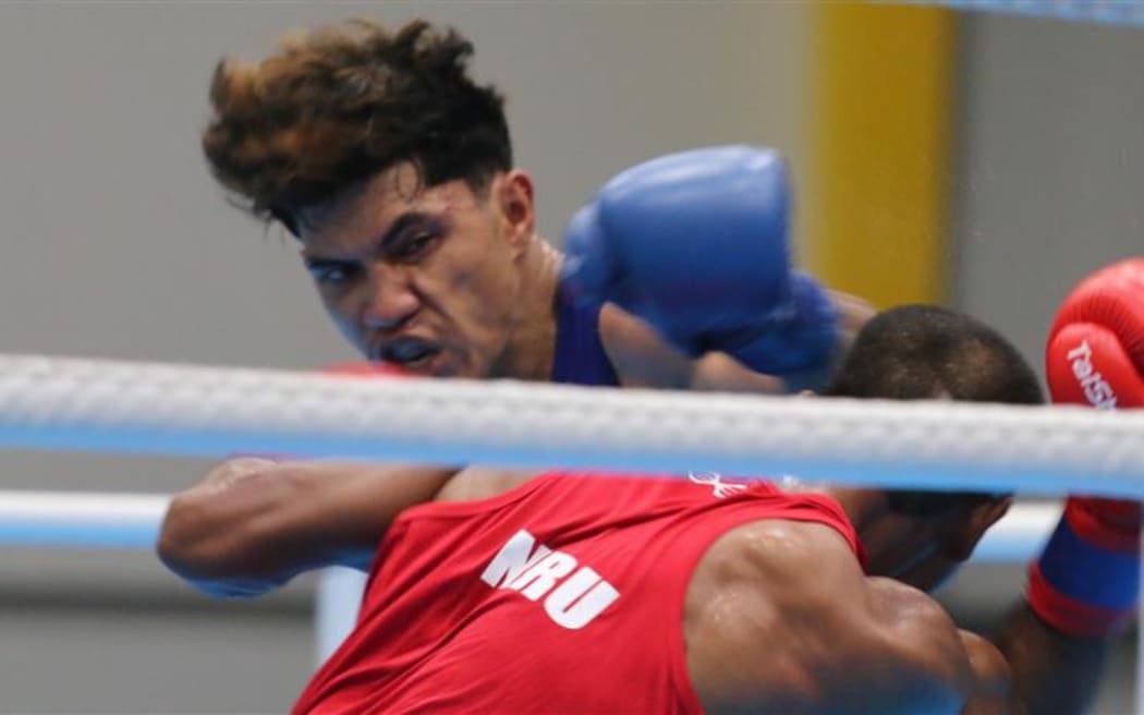 Boxing round of 16 - Nauru’s Gaissa Jones (blue) slips a jab from Samoa’s Jason Wulf. Gaissa won the 67Kg bout 3-0 by split decision. Friendship Hall, Honiara, 27 November 2023.