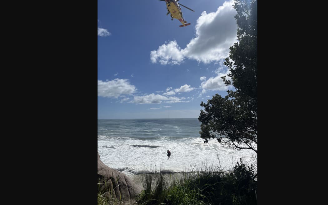 A person being winched at of the Whiritoa blowhole in Coromandel.