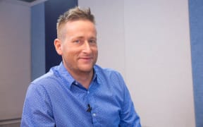 Tim McKinnel sitting in the RNZ Auckland studio after talking with John Campbell
