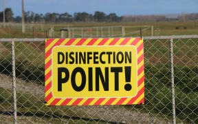 A disinfection point sign on a farm under restricted movement notice due to Mycoplasma Bovis.