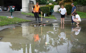 Residents of Sucklings Lane in Rosedale drain their flooded cul-de-sac which was waist high earlier this morning.