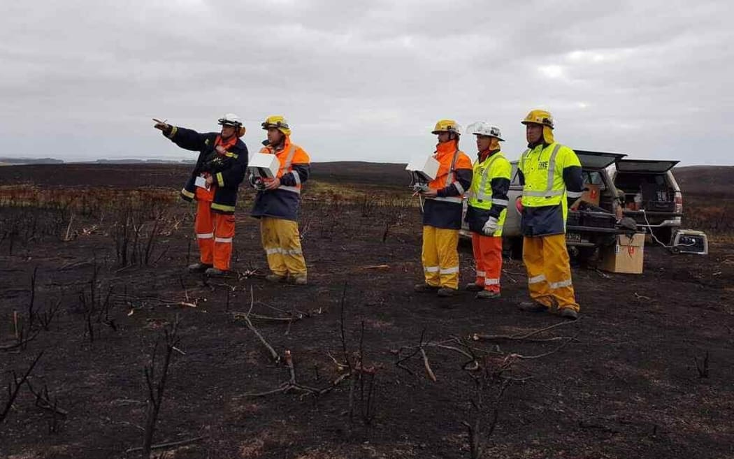 Looking for clues in the fire scorched landscape.
