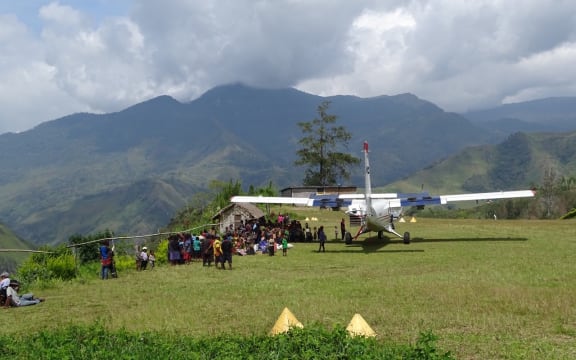 Mission Aviation fellowship aircraft at a rural airstrip, Papua New Guinea.