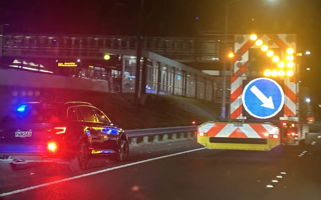 Three police cars have been damaged following a dramatic fleeing driver incident that culminated in the vehicle's tyres being spiked and three lanes of Auckland's Northern Motorway being closed.
