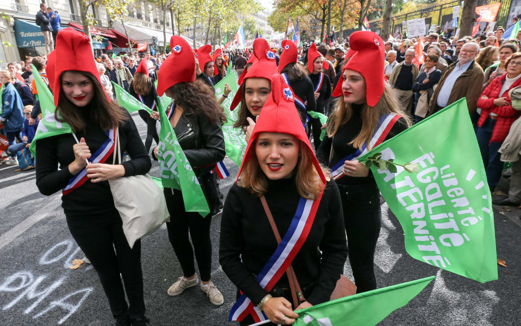 Young girls wearing a Phrygian cap symbolizing the French Republic take part in a protest against a government plan to let single women and lesbians become pregnant with fertility treatments, on October 6, 2019 in Paris.
