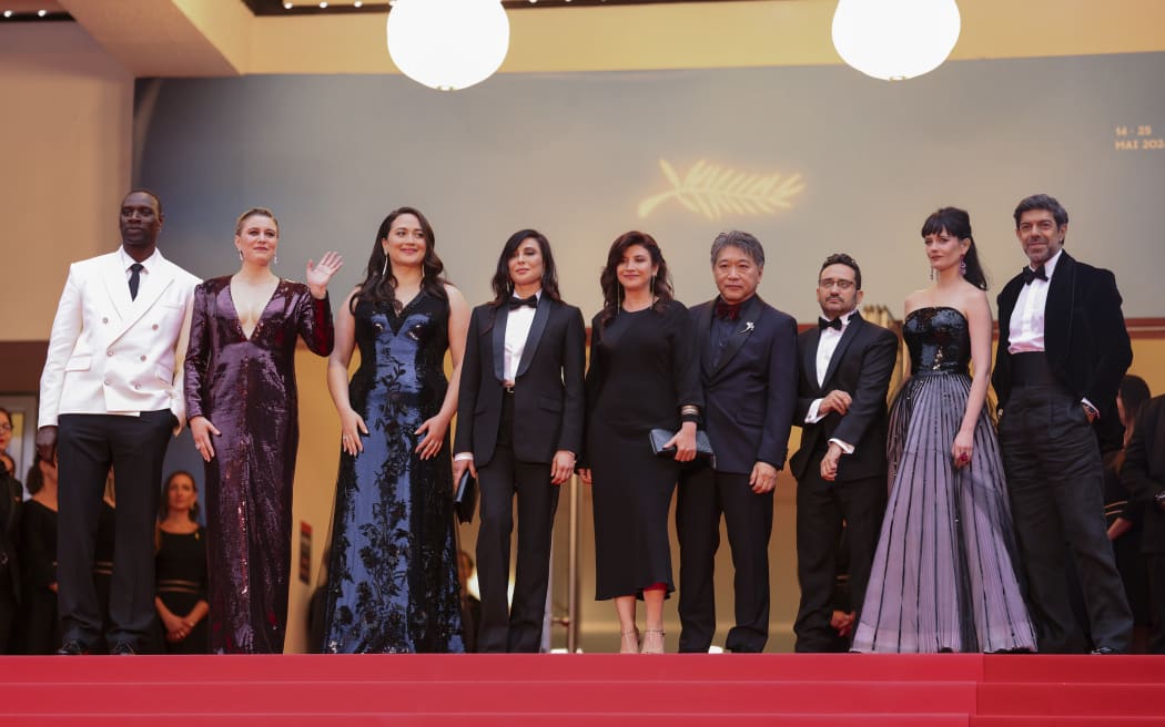 Jury president Greta Gerwig, second form left, poses with jury members Omar Sy, from left, Lily Gladstone, Nadine Labaki, Ebru Ceylan, Kore-eda Hirokazu, J.A. Bayona, Eva Green, and Pierfrancesco Favino on arrival at the awards ceremony and the premiere of the film 'The Second Act' during the 77th international film festival, Cannes, southern France, Tuesday, May 14, 2024. (Photo by Vianney Le Caer/Invision/AP)