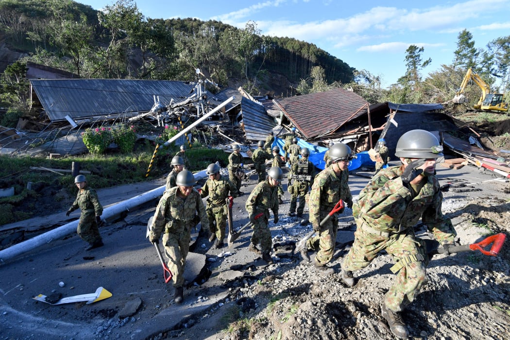 Self Defense Forces of Japan officers conduct a search at a collapsed house due to landslide in Atsuma Town, Hokkaido.